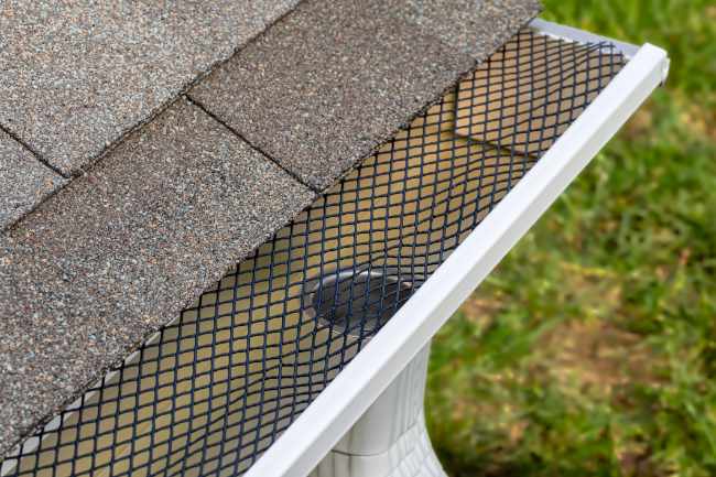 Leaf protection grill on top of a gutter.